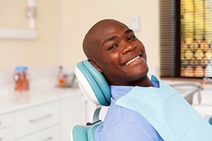 man smiling and knowing why dental checkups and cleanings are important