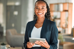 Business woman smiling while holding tablet