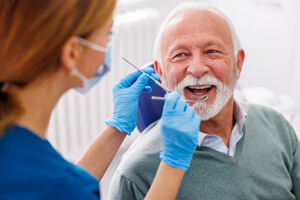 Mature man smiling during dental checkup 