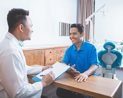  patient talking to dentist about dental insurance 